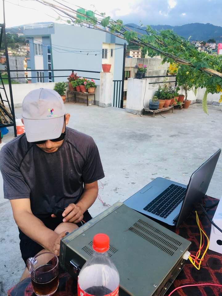 Nabin Poudel operating his HAM radio station on the roof